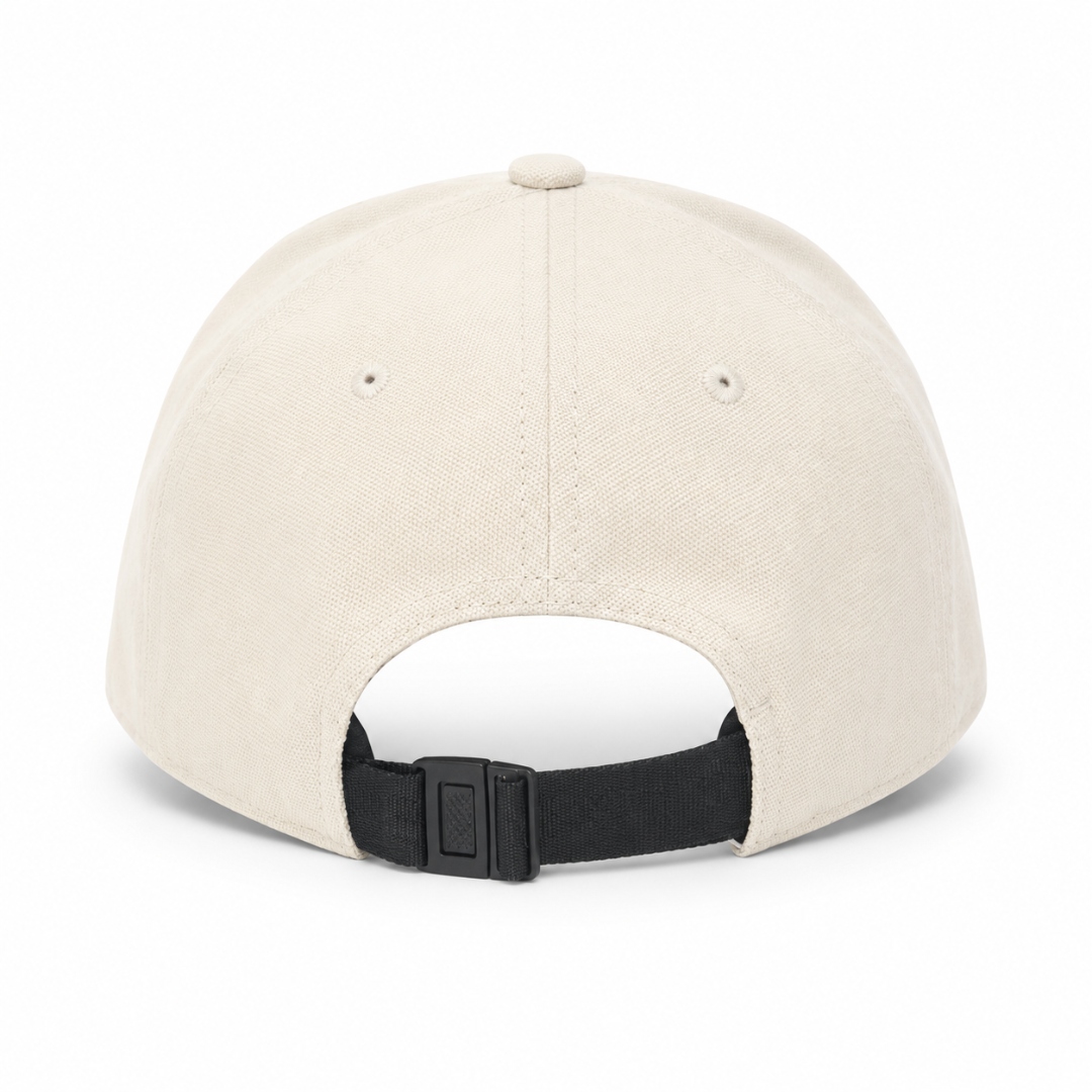 Nylon strap closure with plastic buckle on back of cream cap